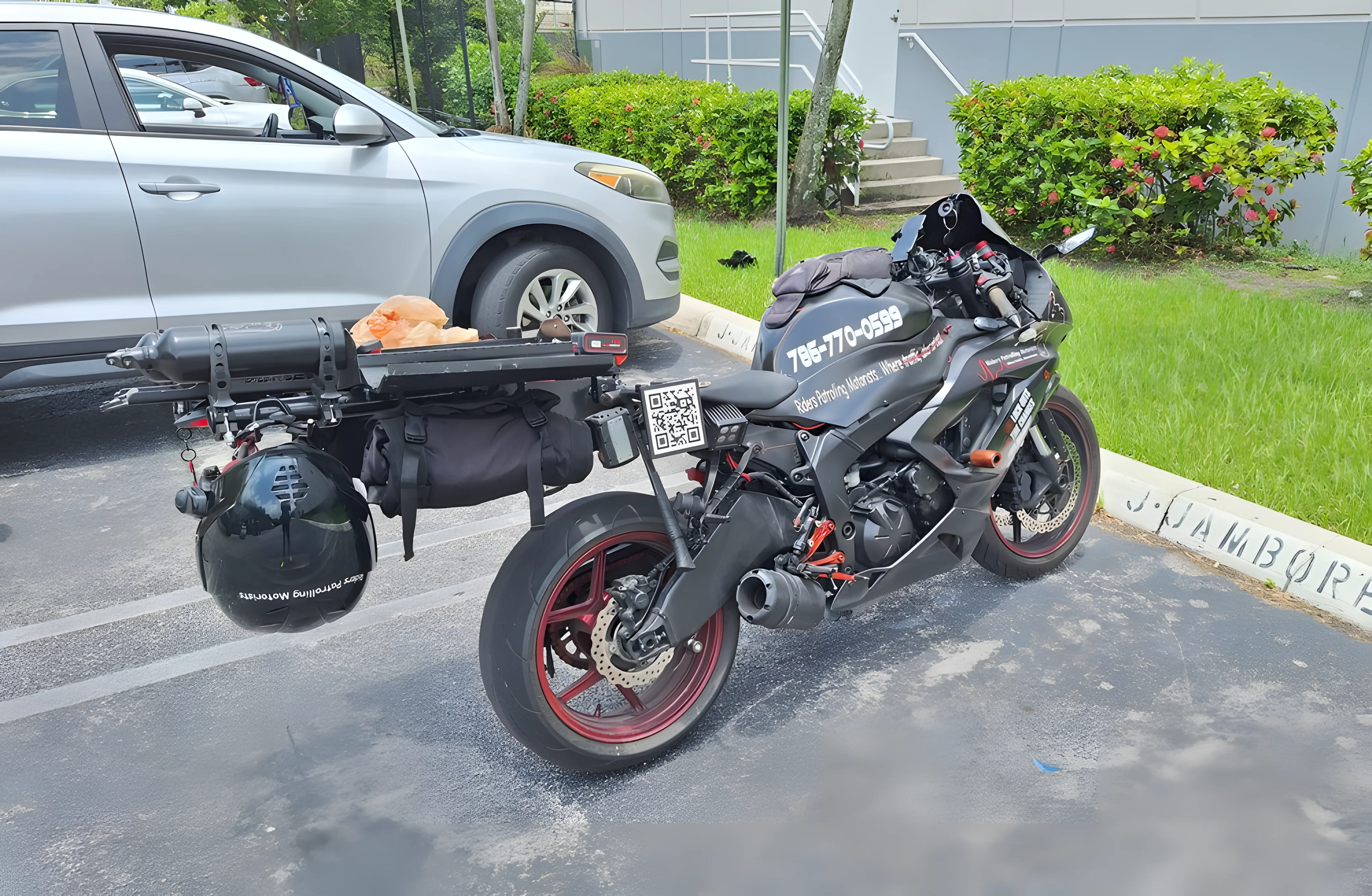 Motorcycle parked with unique equipment and QR code.
